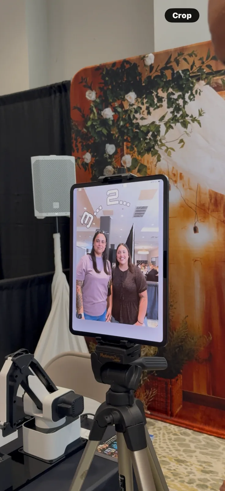 Guests gathered around the AI SketchBot watching a portrait being drawn